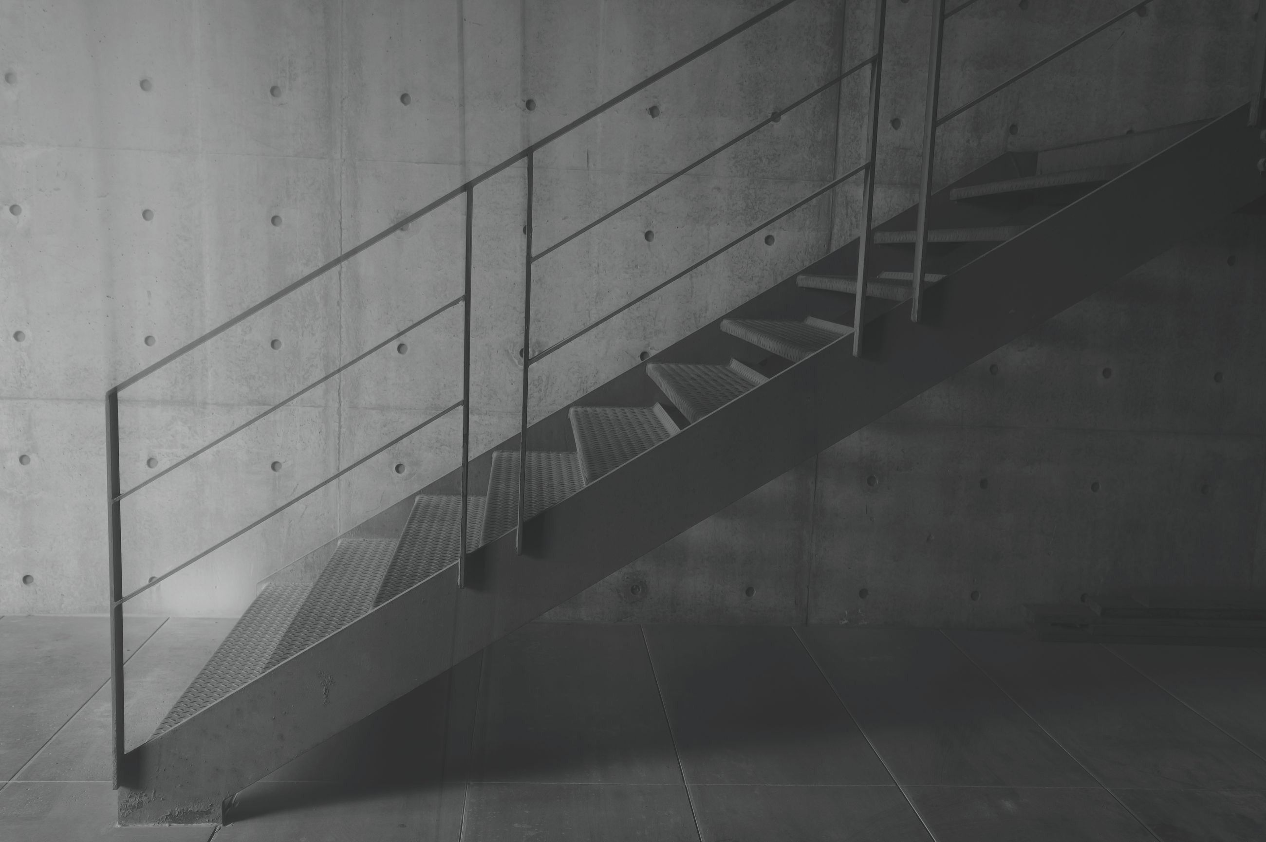 An open doorway with daylight falling across a warm wall